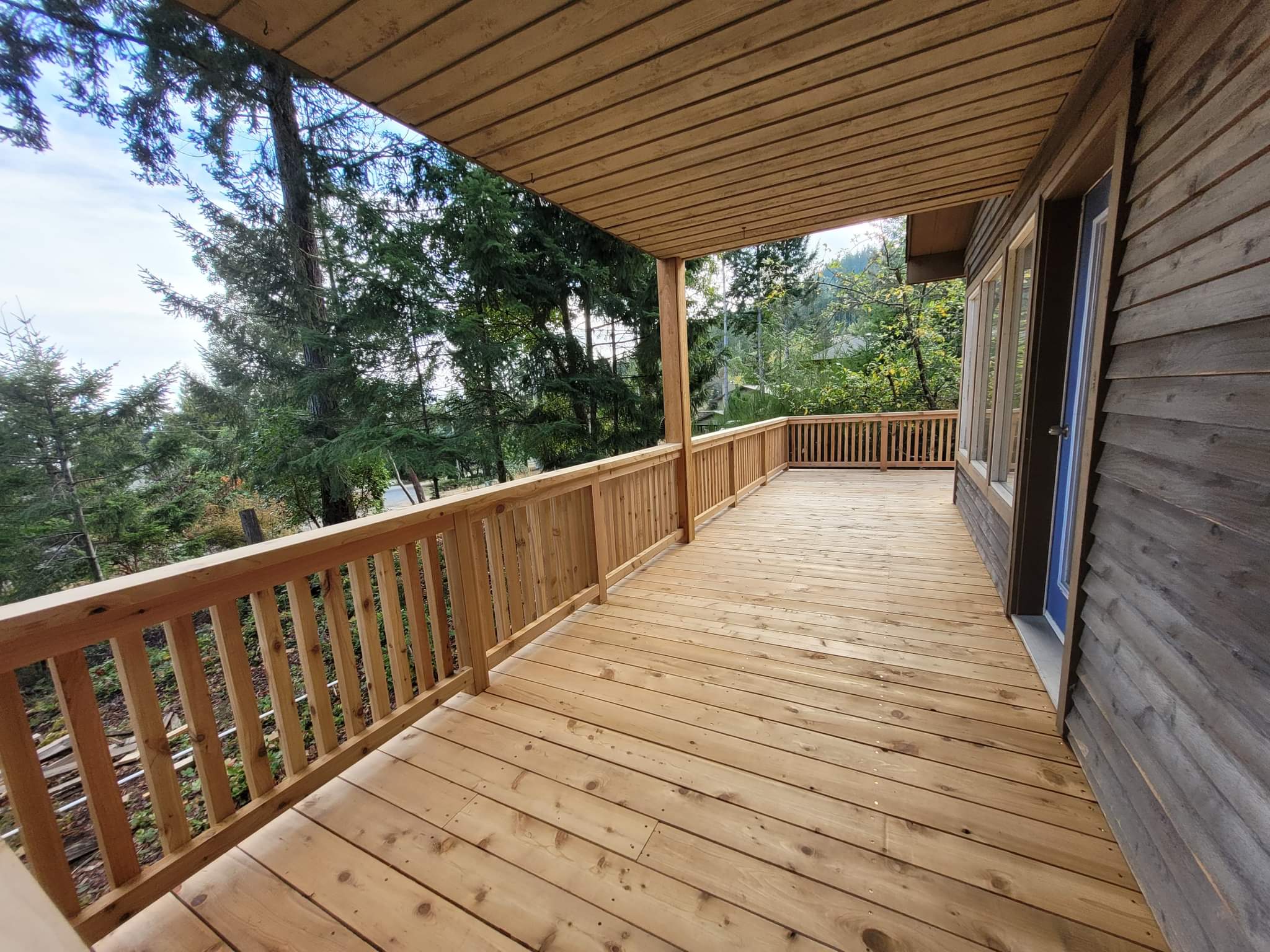 Carlin Road — completed covered cedar deck and balcony repair, clean finish with new decking and railings