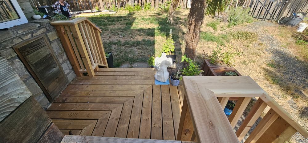 Completed cedar landing and entry stair — waterfront property with stone foundation