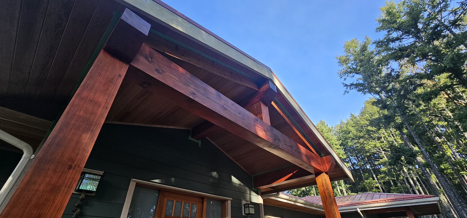 Cedar post-and-beam structure detail — finished timber framing and soffit