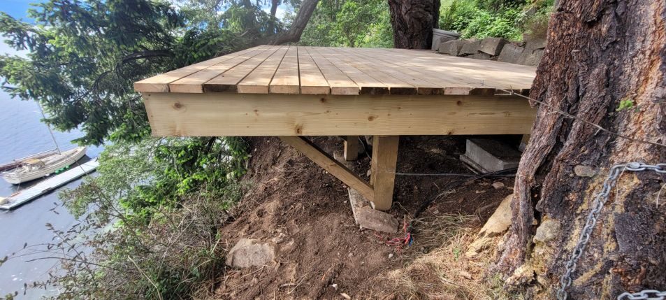 Cedar dock platform on rocky hillside above water — Gulf Islands