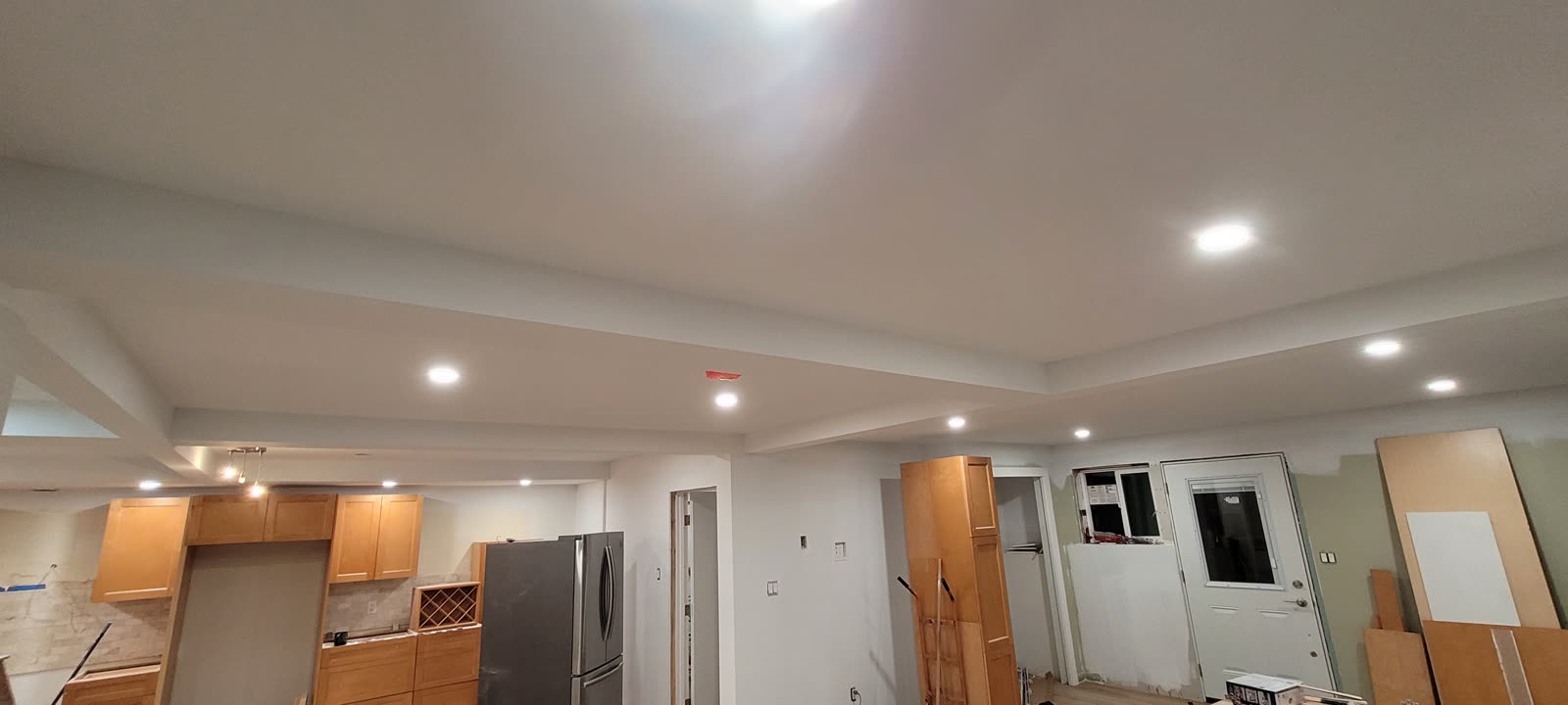 Open-concept basement suite kitchen and living area with LVP flooring