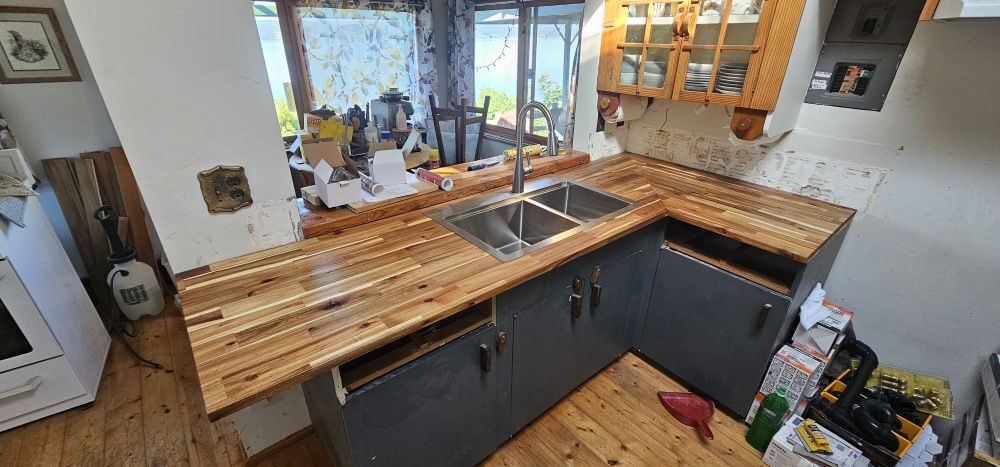 Kitchen renovation with custom butcher block countertop, waterfront view through window