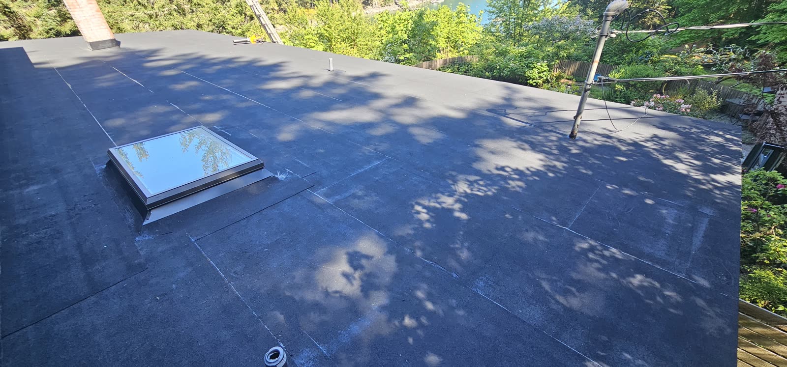 Caffyn Kelly project — completed 2-ply torch-on SBS flat roof with skylight installation, Salt Spring Island