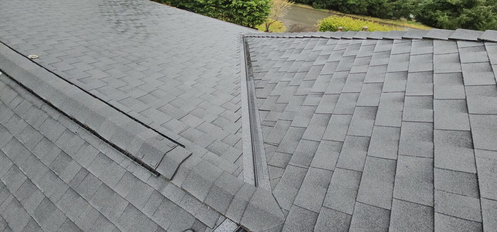 Asphalt reroof completed — clean ridgeline and valley work, island property